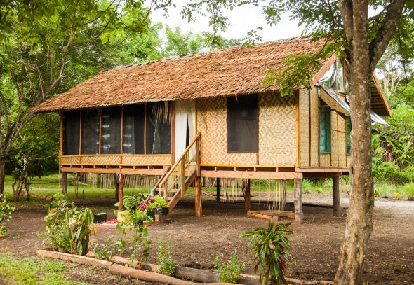 Traditional hut in Milne Bay Papua New Guinea. Photo by Alicia Fox Photography for UK charity, Cool Earth