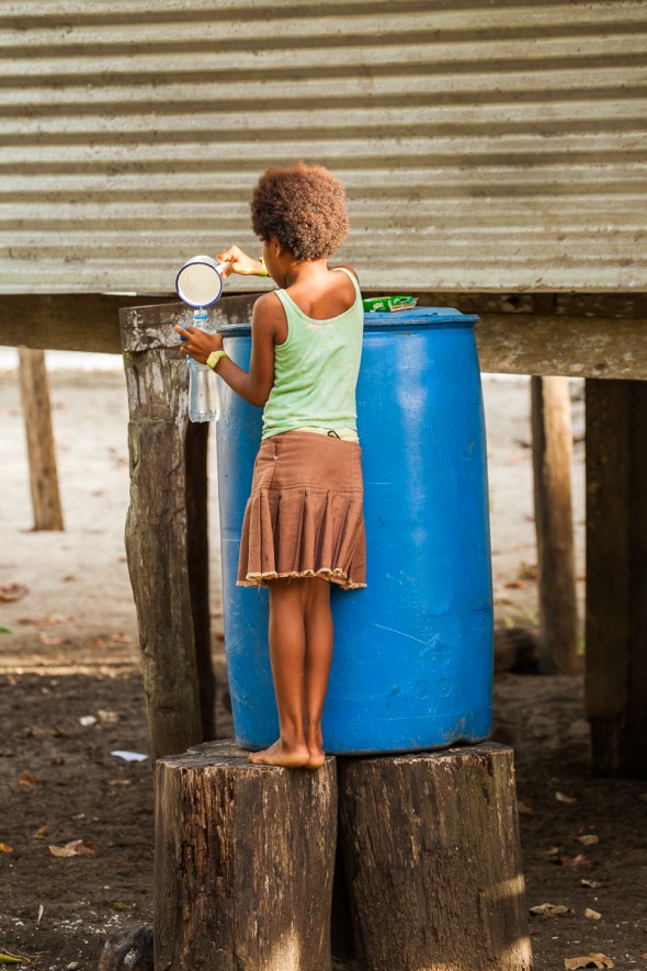 Little girl collecting water in drink bottle PNG