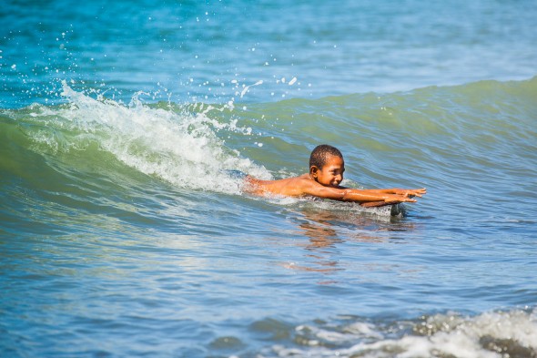 Boy surfing in Papua New Guinea