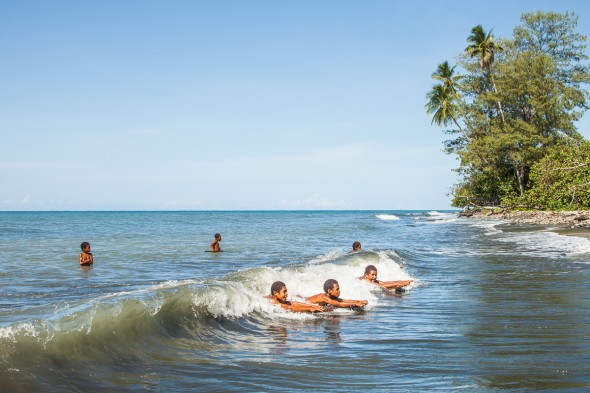 Boys surfing in PNG